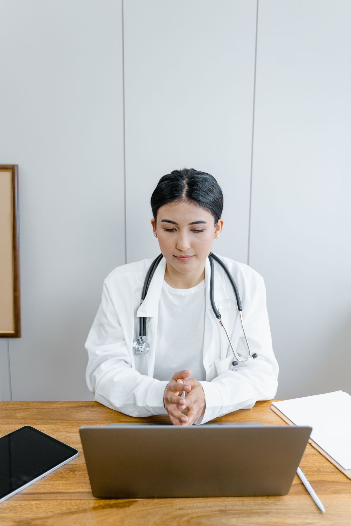 Physician completing credentialing paperwork with a specialist